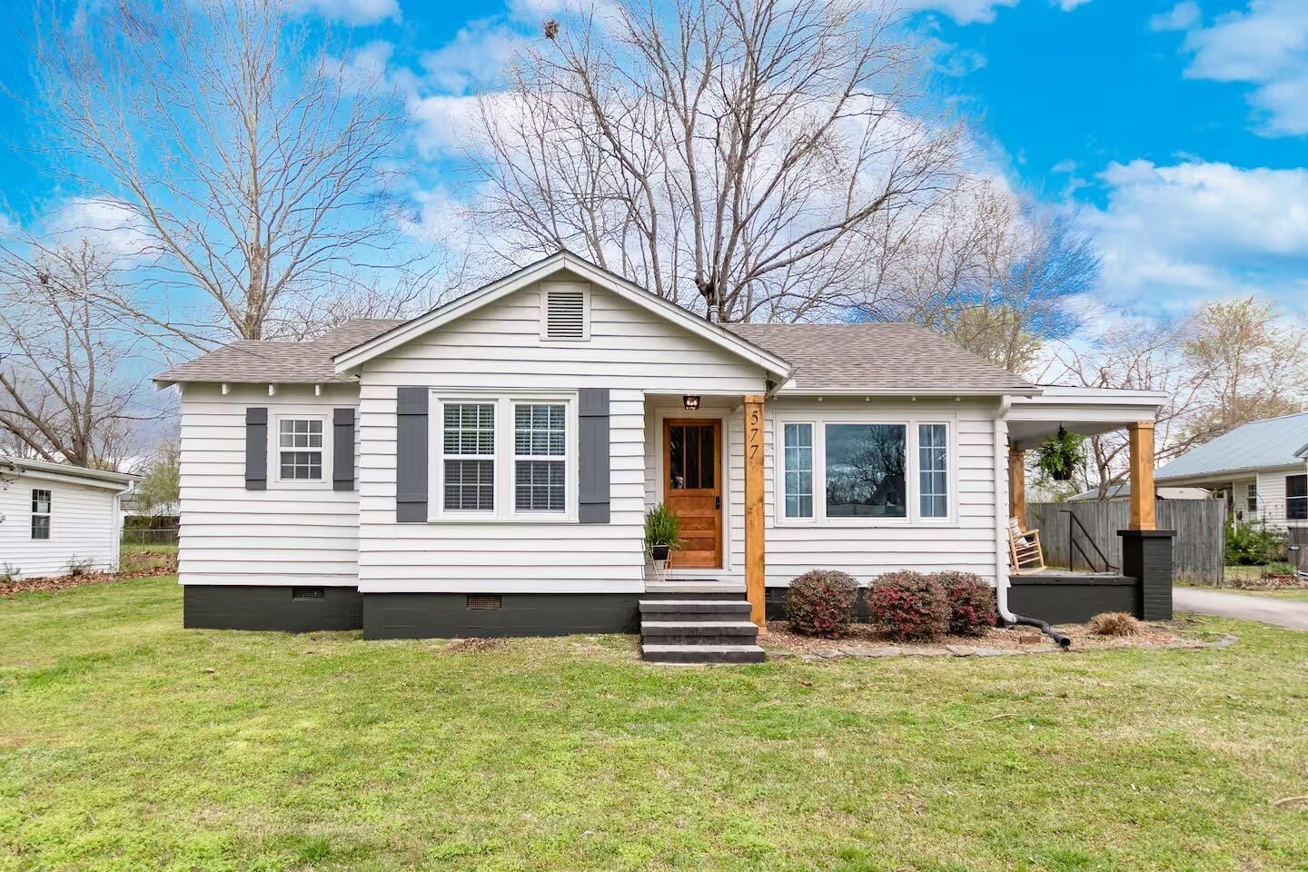 A single-story house with a front porch, a visible garage, and a well-maintained lawn.