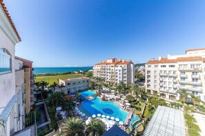 A resort with multiple swimming pools, a beachfront view, and a large building with balconies. - Luxury Penthouse W/sea View Jurere Resort Ilc1506 (Florianópolis)