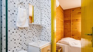 A bathroom with a white sink, a mirror, and a towel hanging on the wall. - Cabin Between Lagoon and Praia do Rosa - Prj004 (Imbituba)