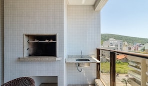 A balcony with a tiled wall, a small window, and a metal sink. - 3br, Pool, sea View, 300m Bombas Beach Csd0403 (Bombinhas)