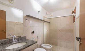 A bathroom with a granite sink, a toilet, and a shower stall. - Comfortable Apartment Beachfront Condo Jso0007 (Porto Seguro)
