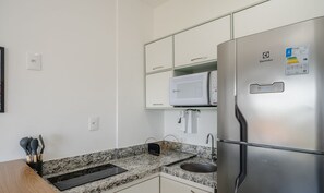 A modern kitchen with a stainless steel refrigerator, a microwave, and a granite countertop. - Apt With a View, 400 m From Barra Beach Blb1206 (Salvador)