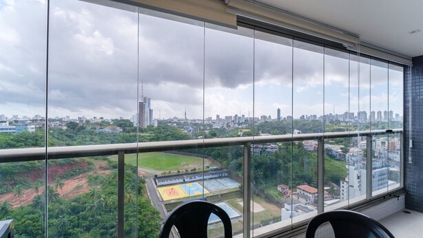 A high-rise room with a large window overlooking a cityscape and a sports field. - Seafront apt in Ondina, With Balcony - Bca2004 (Salvador)