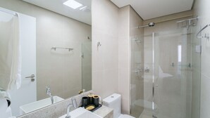 A modern bathroom with a glass-enclosed shower, a large mirror, and a sink with a marble countertop. - Seafront apt in Ondina, With Balcony - Bca2004 (Salvador)