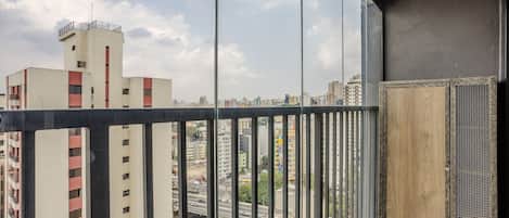 A high-rise building with a view of a cityscape through large windows.