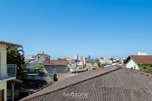 Ein Wohngebiet mit Terrakotta-Dachziegeln, blauem Himmel und verschiedenen Gebäuden im Hintergrund.
