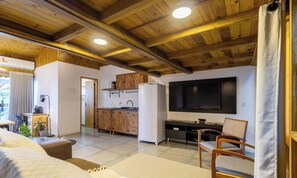 A compact living space with a kitchen, a sofa, a TV, and a dining area. - Modern Loft w/ Balcony Near Beach Nde0003 (Florianópolis)