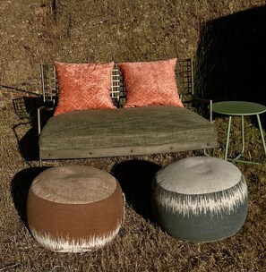 A bed with two pillows, a metal frame, and two round ottomans. - Cozy Glamping by the Eel River and Redwoods (Garberville)