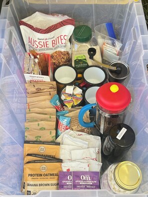 A storage container filled with various food items and kitchenware. - Cozy Glamping by the Eel River and Redwoods (Garberville)