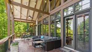 An outdoor deck with a sofa, chairs, and a table. - McLemore Resort - 33 Eagle Creek Trail - Forest Cabin (Rising Fawn)