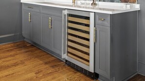A modern kitchen with grey cabinets, a white countertop, and a backsplash with a distressed look. - McLemore Resort - 207 Rushing Water Trail - Golf Course View (Rising Fawn)