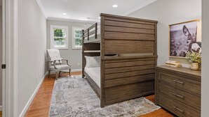 A bedroom with a bunk bed, a chair, a dresser, and a window. - McLemore Resort - 454 Rushing Water Trail - Golf Course View (Rising Fawn)