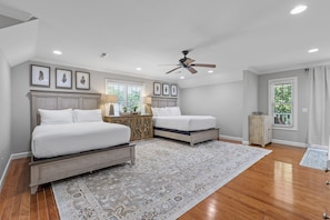 A bedroom with two beds, a ceiling fan, and a large rug. - McLemore Resort - 454 Rushing Water Trail - Golf Course View (Rising Fawn)