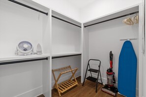 A walk-in closet with shelves, a fan, a vacuum cleaner, and a drying rack. - McLemore Resort - 77 Peregrine Lane - Walking distance to Range and Clubhouse (Rising Fawn)