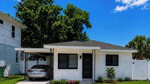 A single-story house with a garage, a front door, and a small porch. - The Lincoln Luxe Studio• Private Retreat • Midtown • Downtown • Stadium  (Tampa)