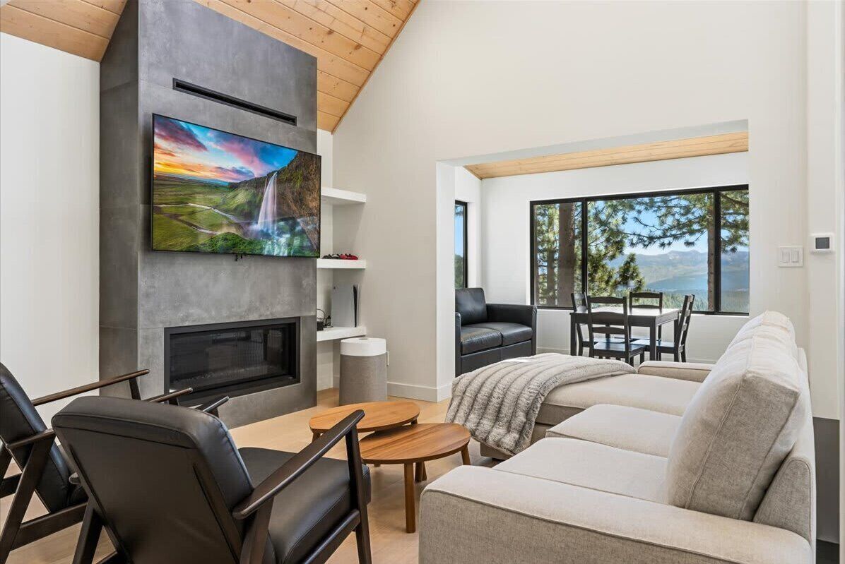 Living room with gas fireplace, TV and valley views
