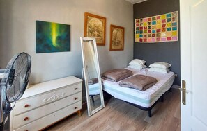 A bedroom with a bed, dresser, mirror, and artwork on the walls. - Gorgeous home in Dolores (Dolores)