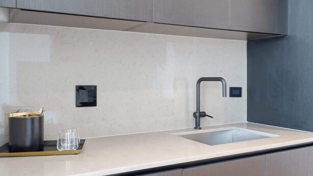 A modern kitchen with a single sink, a faucet, and a countertop. - Stunning E11EVEN Residences Suite Rooftop Pool (Miami)