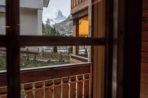 A wooden balcony with a view of a mountain and a wooden fence. - Sophisticated Alpine Stay, Wallis 1078 (Wallis)