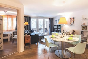 A modern living room with a dining area, large windows, and a cozy seating arrangement. - LuxuryYour Luxury Alpine Escape, Wallis 1070 (Wallis)