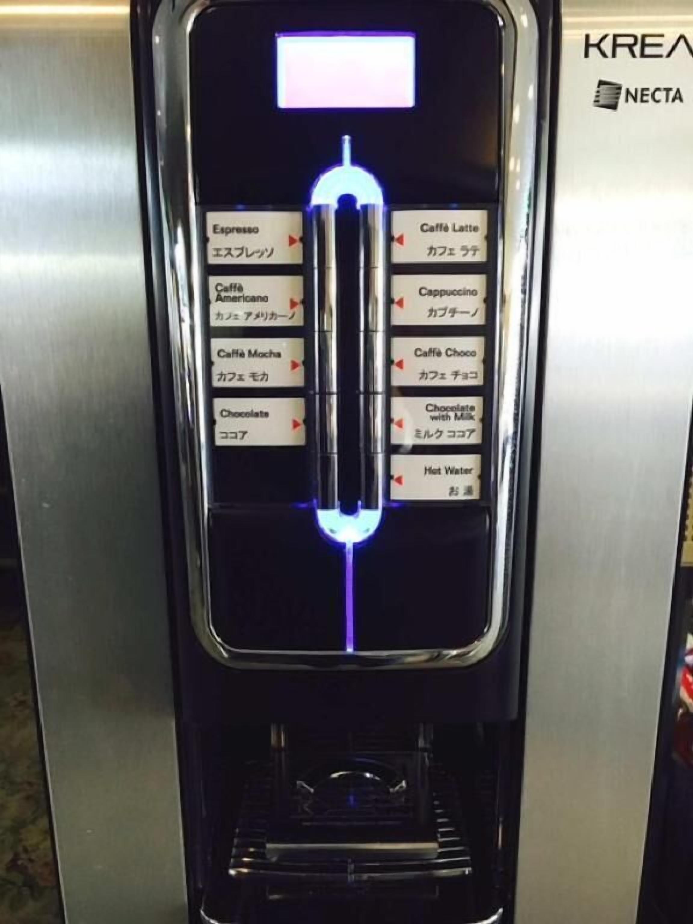 A coffee machine with a digital display and multiple beverage options.