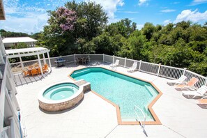 A swimming pool with a hot tub, surrounded by a deck with lounge chairs and a covered seating area. - Soundside-ELEV, Priv pool, HTub, Rec Rm-CC328, Pipers Perch (Corolla)
