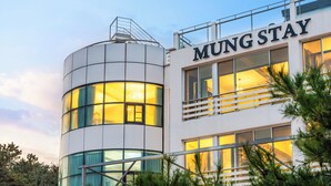 A modern building with a sign that reads 'MUNG STAY'. - Yunseulga Bada (Seoul)