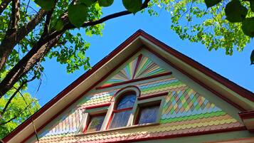 A building with a colorful roof and a window with a blue frame.