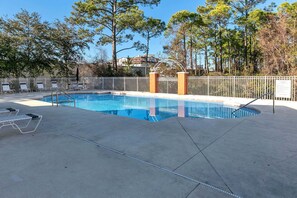 A swimming pool with a white fence, lounge chairs, and trees in the background. - 🦩Book Me Baby! High Tide in Miramar Beach ~ Golf Cart Included🦩 (Miramar Beach)