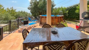 An outdoor patio with a wooden table and chairs, a pool, and a barbecue grill. - Lovely home in Châteauneuf-Villevieil (Châteauneuf-Villevieil)