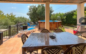 An outdoor patio with a wooden table and chairs, a pool, and a barbecue grill. - Lovely home in Châteauneuf-Villevieil (Châteauneuf-Villevieil)
