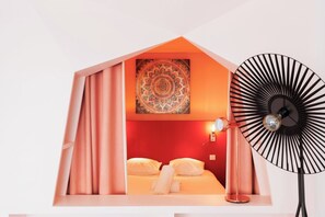 A bedroom with a bed, curtains, a wall-mounted lamp, and a decorative tapestry. - Upstays Elegant Gray d'Albion 2min Palais (Cannes)