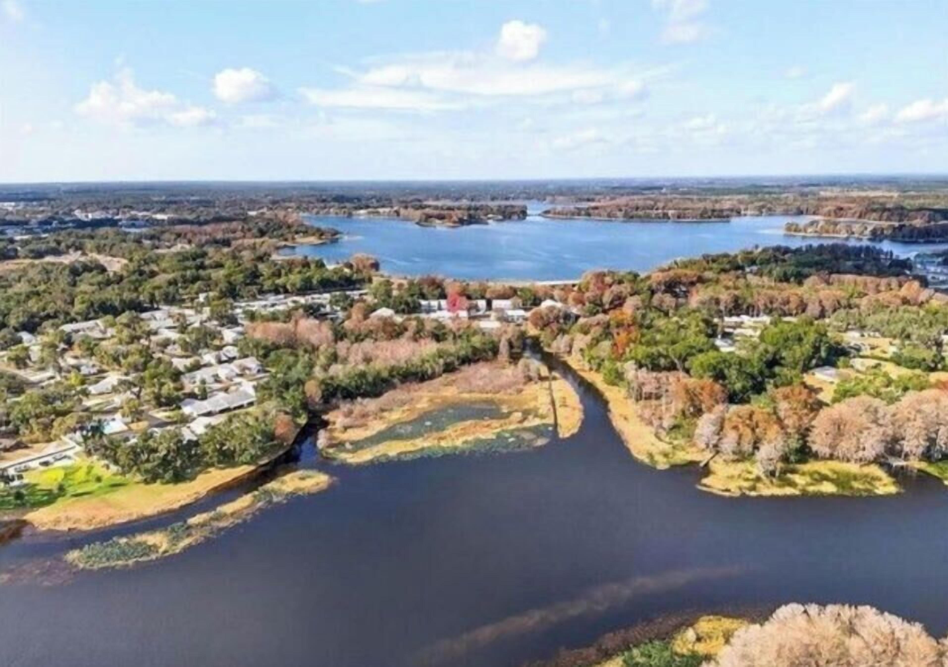 A river meandering through a residential area with houses on both sides.