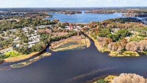 A river meandering through a residential area with houses on both sides.