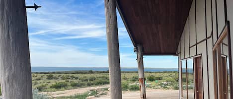 A wooden deck with a view of a natural landscape.