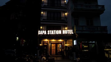 The exterior of Sapa Station Hotel with a prominent illuminated sign.