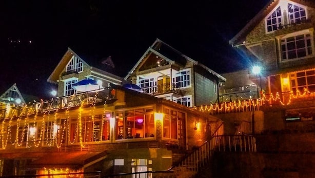 A multi-story building with a covered walkway and stairs leading to the entrance. - Udaan Alpine Resort & Chongeytar (Gangtok)