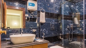 A modern bathroom with a large sink, toilet, and glass-enclosed shower area. - Udaan Alpine Resort & Chongeytar (Gangtok)