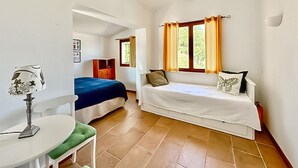 A room with a bed, a sofa, a table with a lamp, and a window with curtains. - Nice home in MONS with private swimming pool, can be inside or outside (MONS)