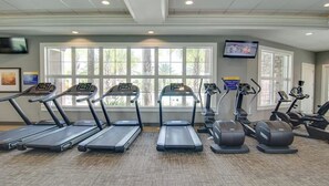 A gym with treadmills, elliptical machines, and weight equipment. - Solterra Resort Pool House 6BR/Sleeps 12 (Davenport)