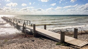 A wooden pier extending into the sea with a rocky shoreline. - Nice home in Assens with WiFi (Assens)