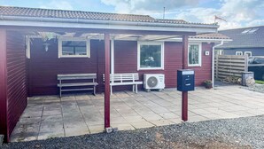 A covered outdoor seating area with benches, a fan, and a mailbox. - Nice home in Assens with WiFi (Assens)