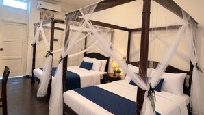 A four-poster bed with white and blue bedding, a ceiling fan, and a nightstand with a lamp and a plant. - Hotel & Recreation Apsara Bukit Residen (Kuala Lipis)