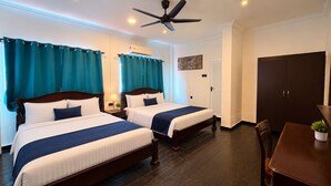 A hotel room with two beds, a ceiling fan, a dining table, and a wardrobe. - Hotel & Recreation Apsara Bukit Residen (Kuala Lipis)