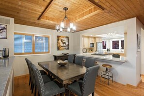 A dining area with a wooden table, six chairs, and a chandelier. - Old Town 3BR | Steps to Town Lift & Main St (Park City)
