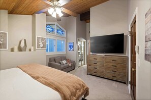 A bedroom with a bed, a TV, a dresser, and a ceiling fan. - Old Town 3BR | Steps to Town Lift & Main St (Park City)