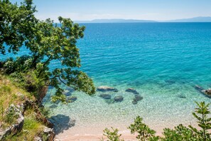 A coastal landscape with clear turquoise waters, rocky shoreline, and lush greenery. - Seaview and Terrace Apartment La Vita, Kostrena, Croatia (Kostrena)