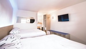 A modern hotel room with two beds, a TV mounted on the wall, and a small desk area. - The Iris Motel - Queen Room (Nashville)