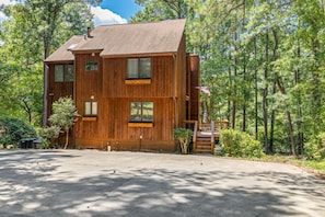 A two-story wooden cabin with a covered porch and a staircase leading to the entrance. - Lakefront, Dock, Firepit, Game Room, Kayaks, Paddleboards (Littleton)
