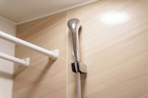 A showerhead mounted on a wall with a white towel bar to its left. - SERENE Osaka | Dotonbori 3F | Spacious 6BR Home · 2 Living Rooms · Sleeps 16 (osaka)